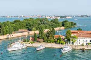 Mediterranean cruise ship docked at a European port with scenic coastline